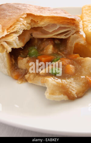 Chicken and vegetable pie with mixed vegetables and chips Stock Photo