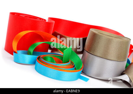 some satin ribbons of different colors on a white background Stock Photo