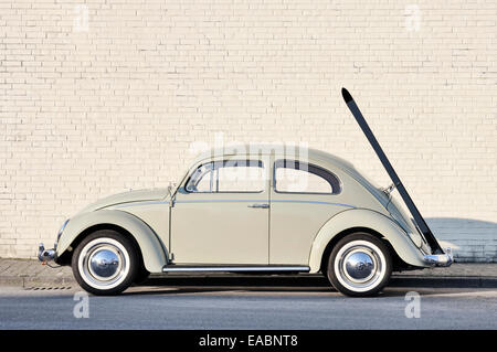 Early 60's Volkswagen Beetle, or informally the Volkswagen Bug,  with original ski rack parked in a street. Stock Photo