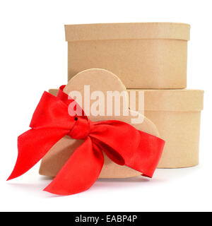 some heart-shaped gift boxes with a red ribbon on a white background Stock Photo