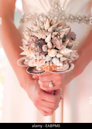 holding a wedding bouquet made of sea shells Stock Photo