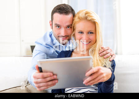 View of a Young attractive couple having fun using tablet Stock Photo