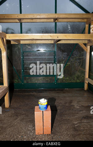 Cleaning an empty greenhouse with a smoke bomb,grenade,sulphur,candle, to kill insects. Stock Photo