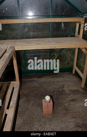 Cleaning a greenhouse with a smoke bomb,grenade,sulphur,candle, to kill insects. Stock Photo