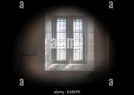Lancaster Castle, Lancashire, UK. View into a prison cell through the warder's spyhole in the door, in the 'Female Felons' Wing'. Stock Photo