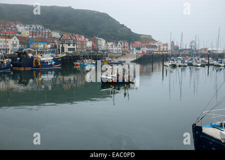 Small fishing boat entering Scarborough harbour. Stock Photo