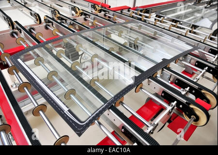 Industry detail with a rear car glass on the production line in a glass factory Stock Photo