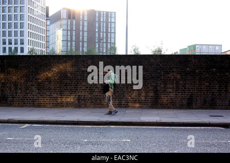Man walking down the street while on his mobile phone Stock Photo