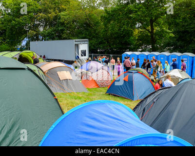 Campers queuing for  showers at festival campsite. Stock Photo