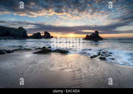 Low tide and sunset at Porthcothan Beach on the north coast of Cornwall Stock Photo