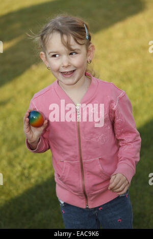 girl is happy after finding Easter egg Stock Photo