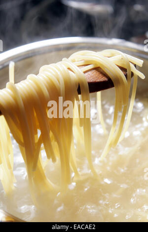 Some spaghetti are cooking in hot water Stock Photo