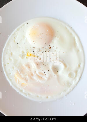 two cooked eggs on plate Stock Photo