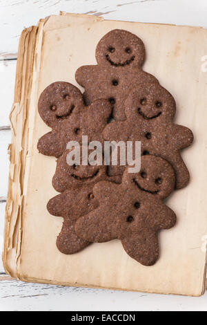 Gingerbread men on vintage cookbook Stock Photo