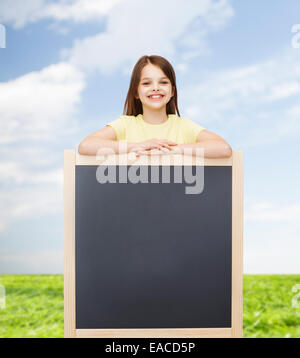 happy little girl with blank blackboard Stock Photo