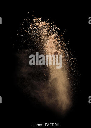 Freeze motion of white dust explosion isolated on black background Stock Photo