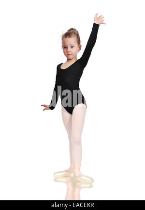 Little ballerina in pointe standing on floor Stock Photo