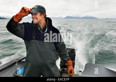 Commercial halibut fishing by hand using longline gear out of an open skiff in Kachemak Bay, Kenai Peninsula; Alaska, USA Stock Photo