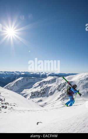 Skier walking in the mountains Stock Photo