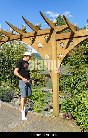 arbour with rocks, graces the front entrance to  garden Stock Photo