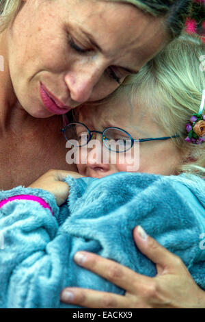 Woman child cry mother comforting, mother-daughter sadness, hug sad child crying mother hugging daughter cries Stock Photo