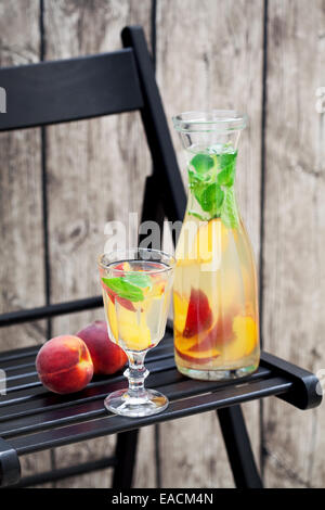 Glass Of Fresh Peach Lemonade With Mint On Black Table Stock Photo - Alamy