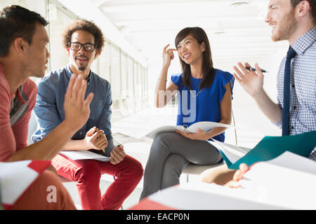 Creative business people meeting in circle of chairs Stock Photo