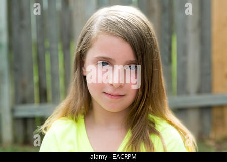 Blond kid girl happy portrait outdoor at backyard Stock Photo