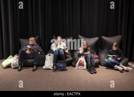 People reading newly bought books at book fair in Vilnius, capital of Lithuania Stock Photo