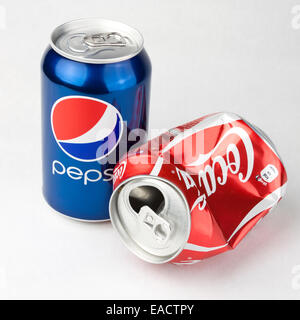 Photo of Coca-Cola and Pepsi classic 330 ml cans. Concept of  competitiveness as Coca-Cola can is lying crashed Stock Photo