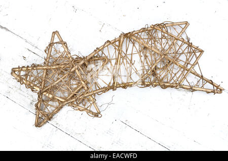 Wicker golden shooting star on white background wood Stock Photo