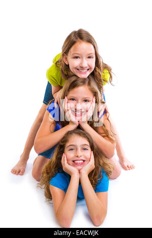 Three kid girls friends happy stacked in a row portrait on white background Stock Photo