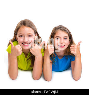 two kid girls happy ok thumbs up gesture expression lying on white background Stock Photo