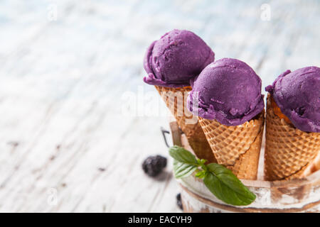 Studio photo of ice cream scoops in waffle cones. Served on wooden planks Stock Photo