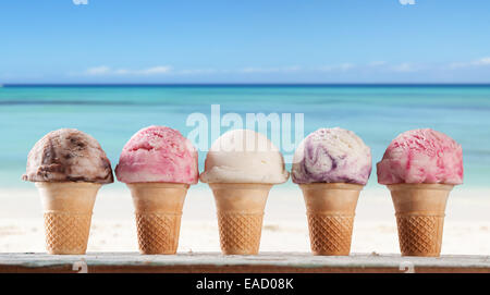 Set of various kind of fruit ice cream on wooden deck with blur sea on background Stock Photo