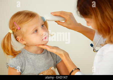 Pediatrician taking temperature with professional thermometer. Stock Photo