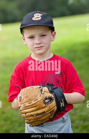Little boy dressed ina baseball uniform with a baseball glove ready to play Stock Photo