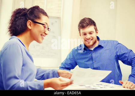 smiling team with paper at office Stock Photo