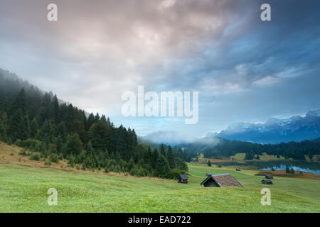 misty sunrise over alpine meadows by Geroldsee lake, Germany Stock Photo