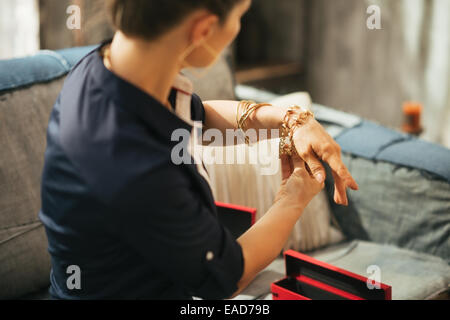 Closeup on young woman trying jewelry. rear view Stock Photo