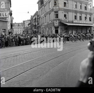 1950s historical picture of a city-centre cycle race, Belgium with riders cycling over tram lines in the street. Stock Photo