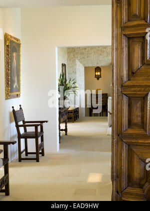 Hallway with carved wooden Door and Chairs Stock Photo