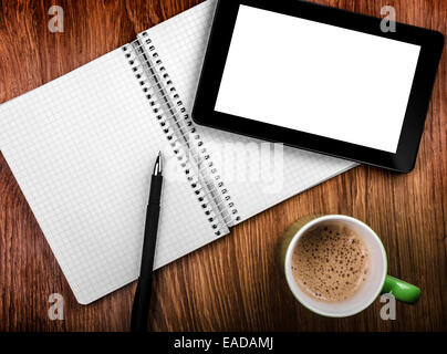 Tablet pc with an empty screen in hands close to a pen and green cup Stock Photo