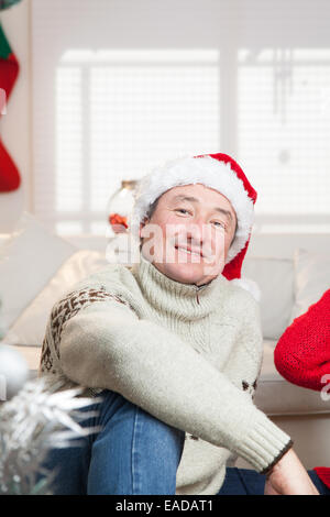 Man sitting with a hat of christmas Stock Photo