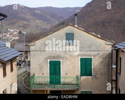 house with green shutters in small italian mountain village Stock Photo