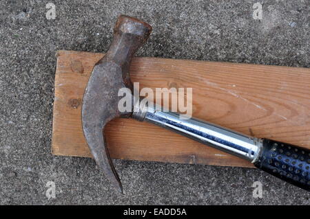 Old Claw Hammer ans a Two By Four Piece of lumber Stock Photo