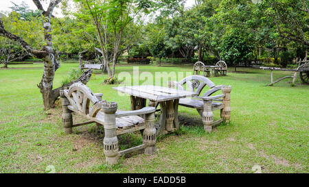 Old wooden tables and bench for relaxing in the park Stock Photo
