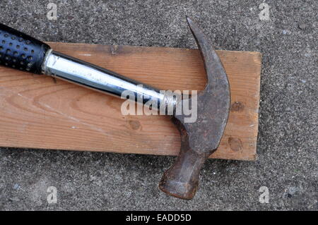 Old Claw Hammer with a Two by Four Piece of lumber Stock Photo