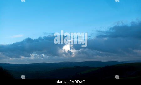 Carmarthenshire,Wales, UK. Wed 12th Nov 2014. November autumn weather today is a mixture of rain, sunny periods and intense colour.  Blue sky and dark clouds end the day over the Epynt moor in Powys and hills near Llandovery.  Kathy deWitt/AlamyLiveNews Stock Photo