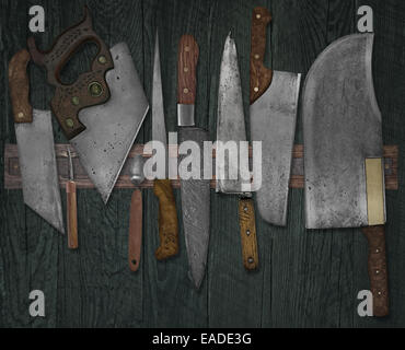 vintage set of knives on the magnet rack against wall, faded colors Stock Photo